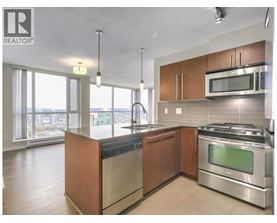 A modern kitchen with stainless steel appliances and wooden cabinets.