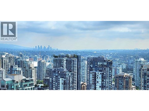 A cityscape with a realtor logo in the corner.