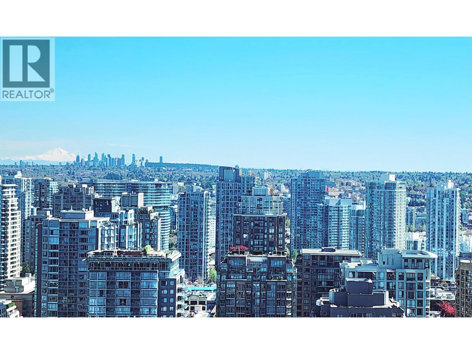 A cityscape with a clear blue sky and a logo that reads "REALTOR" in the top left corner.