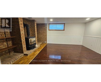 A room with a wood stove and a window.