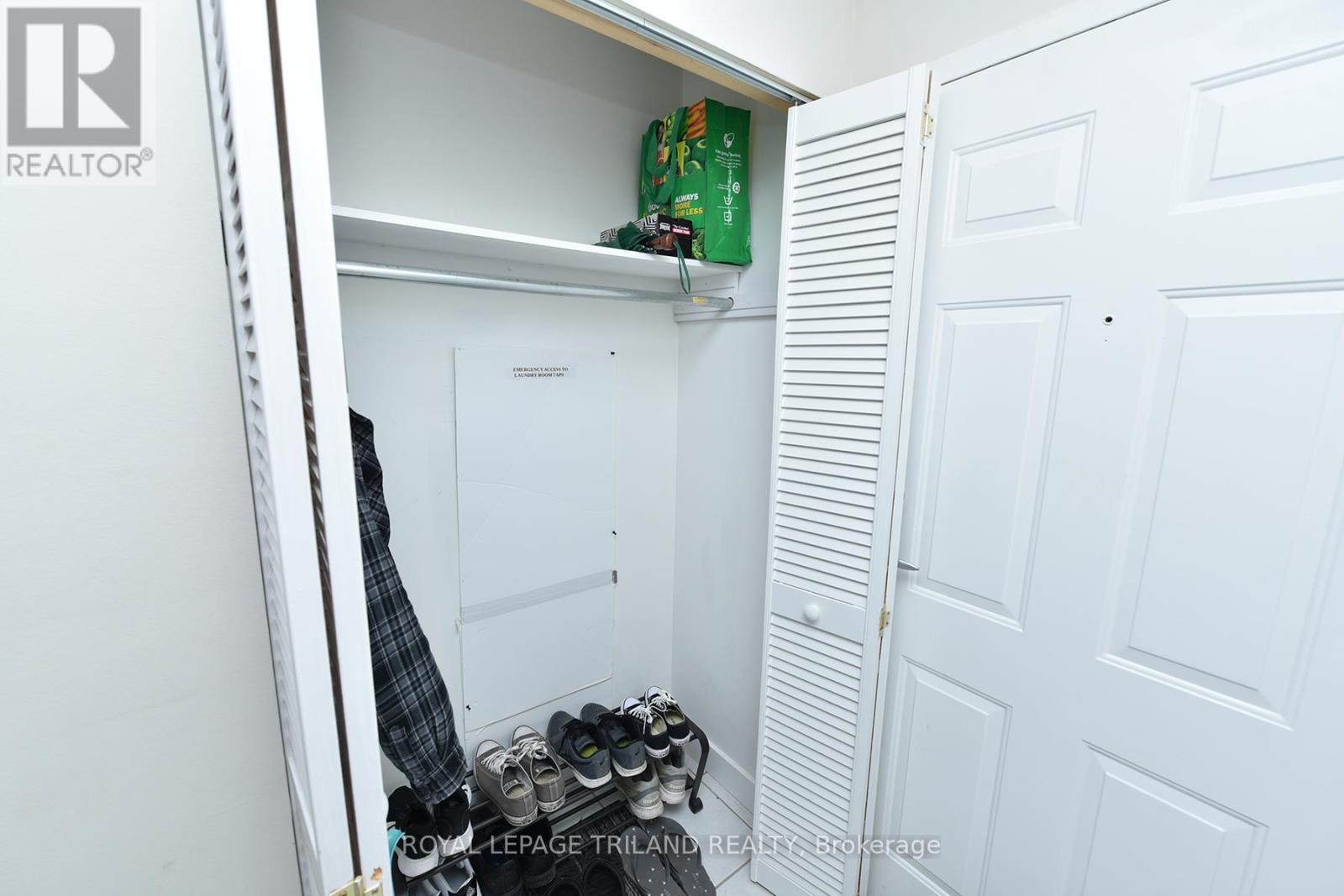 A white closet with a shoe rack and a pair of shoes.