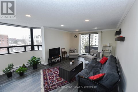 A living room with a black couch and a television.