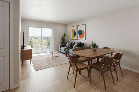 A dining room with a table and chairs.