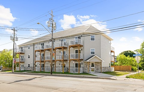 A large apartment building with a balcony on the second floor.