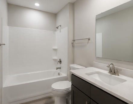 A white bathroom with a toilet, sink, and tub.