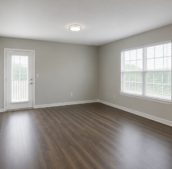 A room with a wooden floor and a window with blinds.