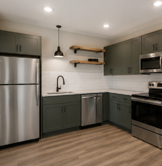 A kitchen with a stainless steel refrigerator and wooden shelves above the counter.