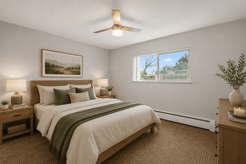 A bedroom with a large bed and a painting on the wall.