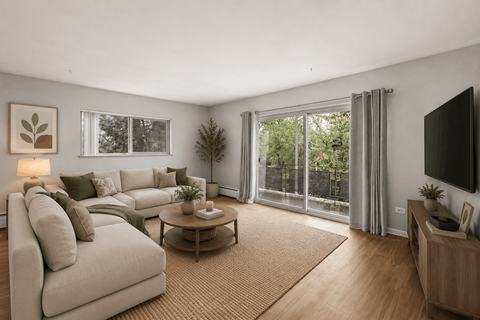 A living room with a couch, coffee table, and sliding glass doors.
