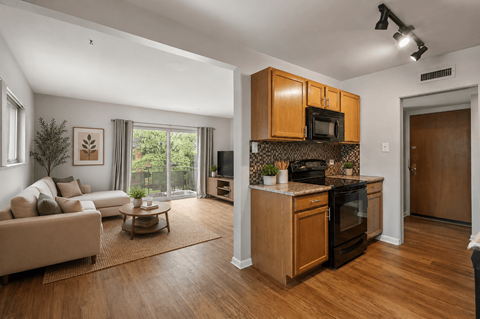 A modern kitchen with wooden cabinets and appliances.