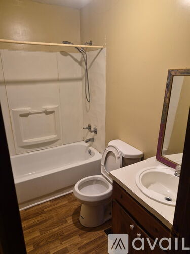A bathroom with a toilet, sink, and bathtub.