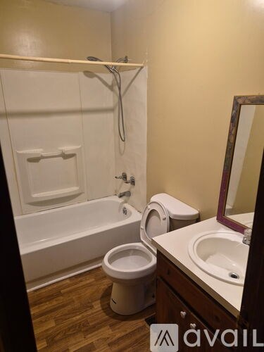 A bathroom with a toilet, sink, and bathtub.