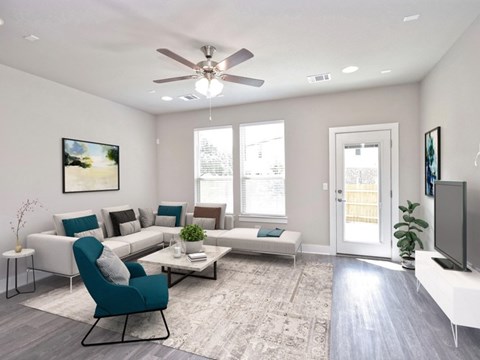 A living room with a blue chair and a white couch.