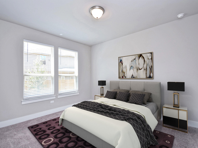 A bedroom with a large bed and a painting on the wall.