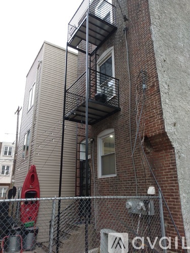 A building with a sign that says "avail" in front of it.