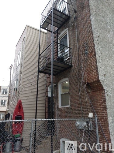 A building with a sign that says "avail" in front of it.