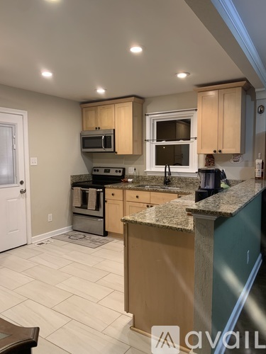 A kitchen with wooden cabinets and granite countertops.
