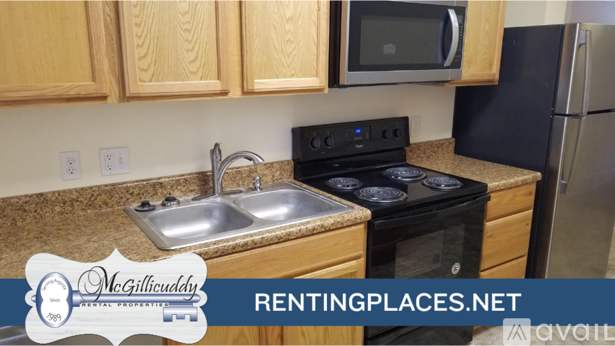 A kitchen with a stove top oven and a microwave above it.