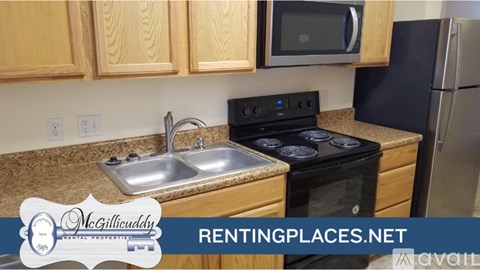 A kitchen with a stove top oven and a microwave above it.