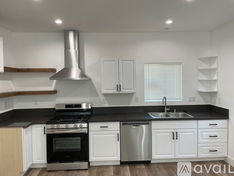 A modern kitchen with a stainless steel dishwasher and oven.