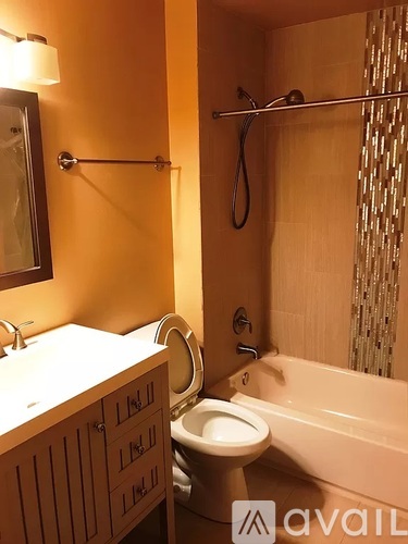 A bathroom with a toilet, sink, and bathtub.