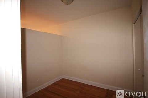 A room with wooden floors and white walls.