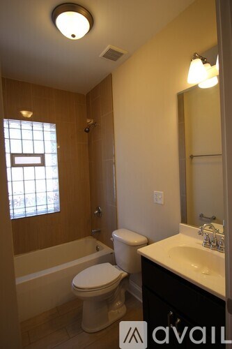 A bathroom with a toilet, sink and tub.