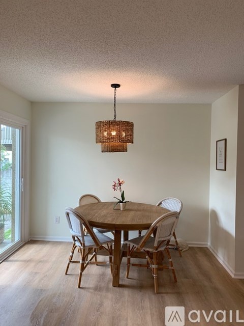 A dining room with a wooden table and chairs.
