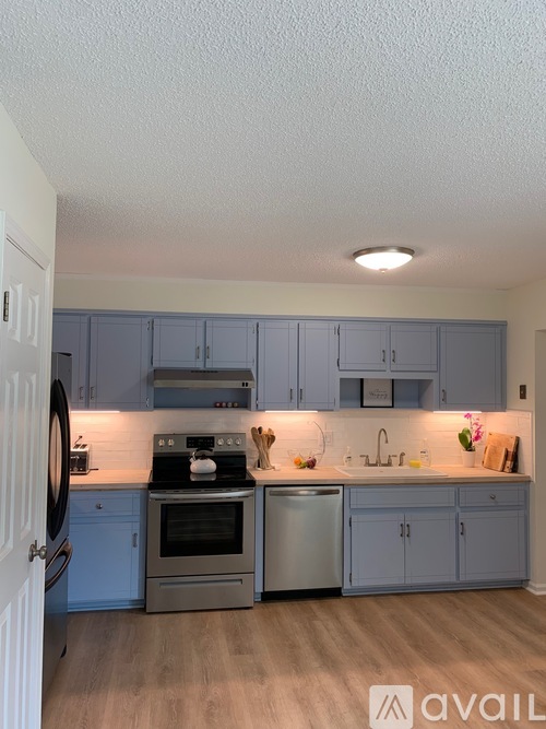 A kitchen with a stove, oven, and cabinets.