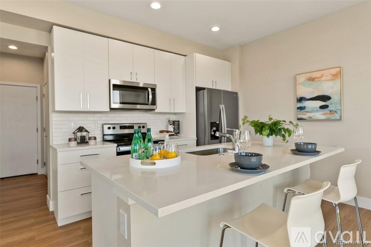 A modern kitchen with white cabinets and a central island.