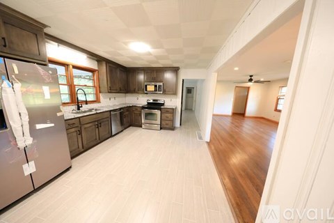 A kitchen with a refrigerator, oven, and microwave.