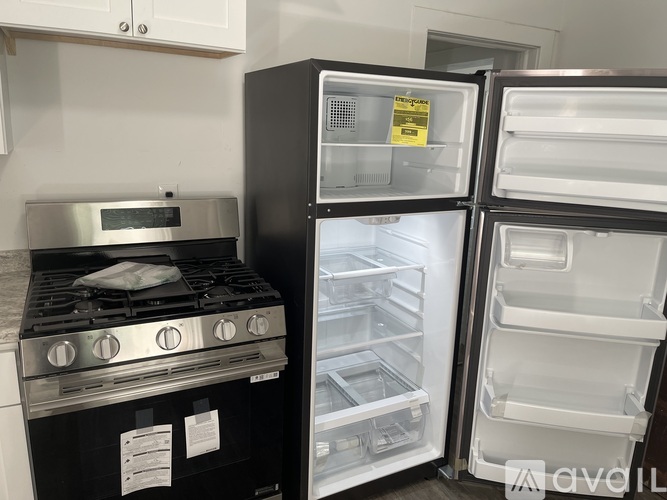 A black stove is in a kitchen next to a black refrigerator.