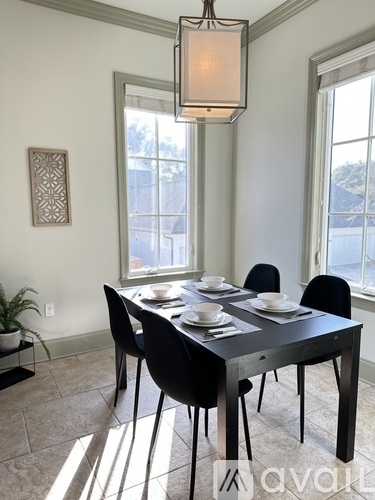 A dining room with a table set for four.