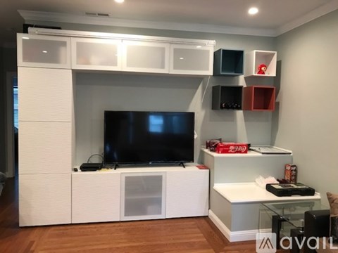 A modern living room with a television and entertainment center.