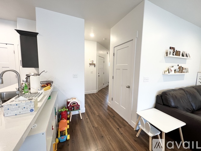 A kitchen with a sink and a toy car on the floor.