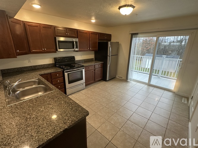 A kitchen with granite countertops and stainless steel appliances.