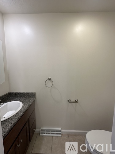 A bathroom with a toilet, sink, and shower.