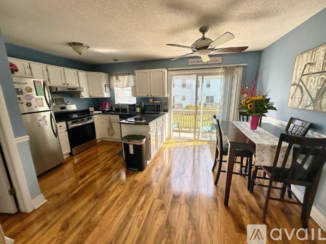 A kitchen with wooden floors and a dining table set up.