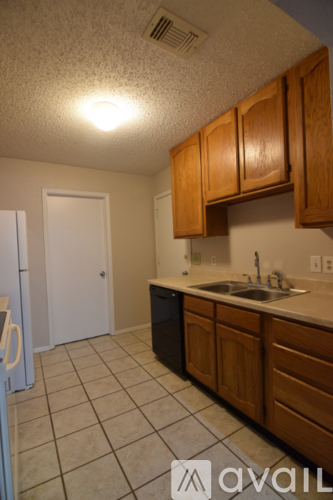 A kitchen with wooden cabinets and a white refrigerator.