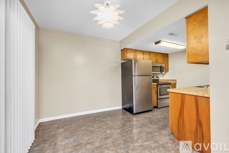 A kitchen area with a refrigerator, microwave, and oven.