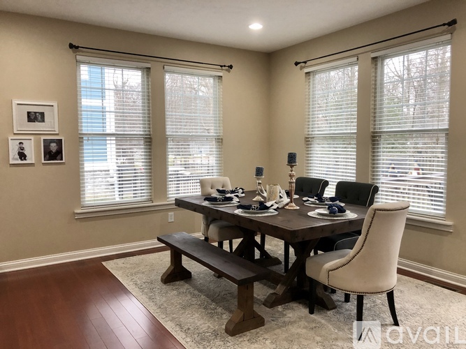 A dining room with a wooden table and chairs.