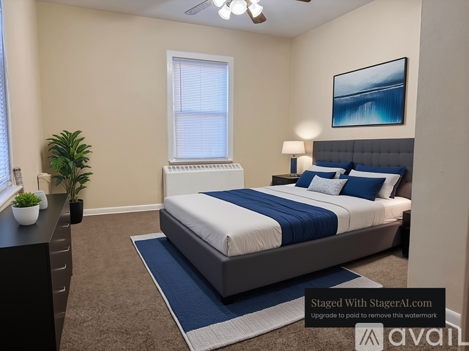 A bedroom with a large bed and a painting on the wall.