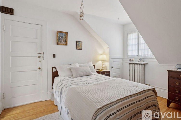 A bedroom with a large bed and a white door.