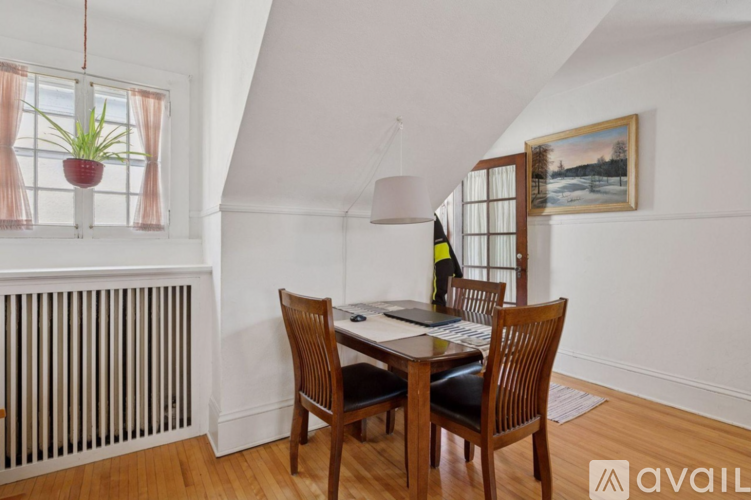 A dining room with a table and chairs.