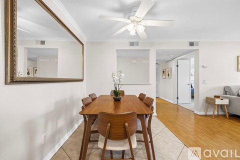 A dining room with a wooden table and chairs.
