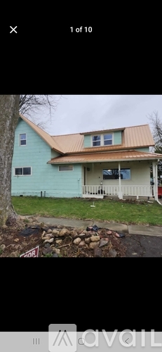 A house with a blue exterior and a brown roof.