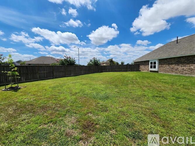 A backyard with a fence and a small building.