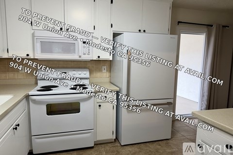 A kitchen with a white oven and microwave, and a white fridge.
