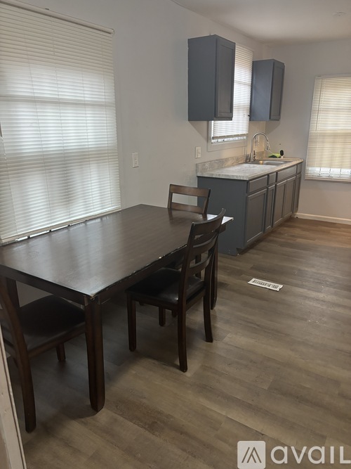 A kitchen with a table and chairs in the foreground.