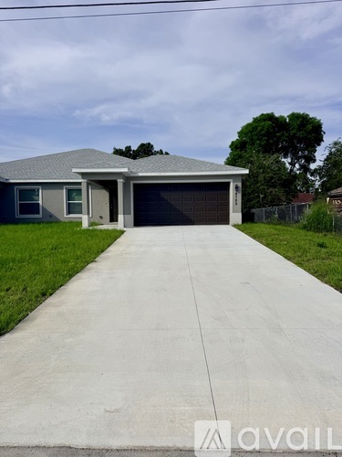 A house with a grey roof and a grey garage door.